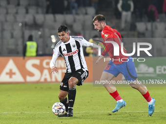 Lucas Gabriel Masoero and Daniel Popa are in action during the Superliga match between Universitatea Cluj and FCSB at Cluj Arena in Cluj, Ro...