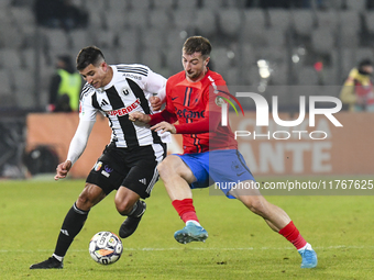 Lucas Gabriel Masoero and Daniel Popa are in action during the Superliga match between Universitatea Cluj and FCSB at Cluj Arena in Cluj, Ro...