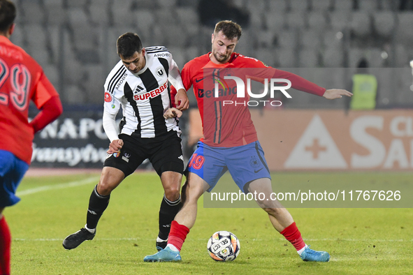 Lucas Gabriel Masoero and Daniel Popa are in action during the Superliga match between Universitatea Cluj and FCSB at Cluj Arena in Cluj, Ro...