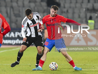 Lucas Gabriel Masoero and Daniel Popa are in action during the Superliga match between Universitatea Cluj and FCSB at Cluj Arena in Cluj, Ro...