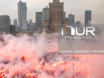 Thousands of people gather and  burning smoke flares during the Independence Day march in Warsaw. National Independence Day - a public holid...