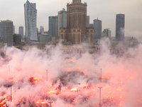 Thousands of people gather and  burning smoke flares during the Independence Day march in Warsaw. National Independence Day - a public holid...