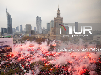 Thousands of people gather and  burning smoke flares during the Independence Day march in Warsaw. National Independence Day - a public holid...