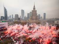 Thousands of people gather and  burning smoke flares during the Independence Day march in Warsaw. National Independence Day - a public holid...