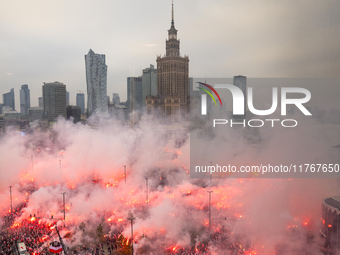 Thousands of people gather and  burning smoke flares during the Independence Day march in Warsaw. National Independence Day - a public holid...