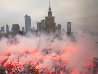 Thousands of people gather and  burning smoke flares during the Independence Day march in Warsaw. National Independence Day - a public holid...