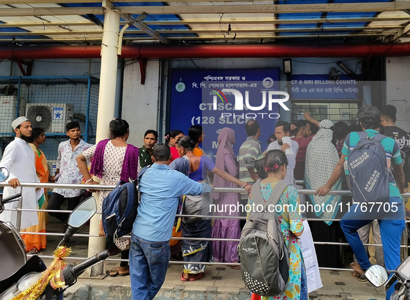 People stand outside a billing counter inside a government-run hospital in Kolkata, India, on November 11, 2024. 