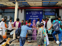 People stand outside a billing counter inside a government-run hospital in Kolkata, India, on November 11, 2024. (