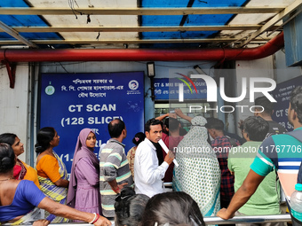 People stand outside a billing counter inside a government-run hospital in Kolkata, India, on November 11, 2024. (