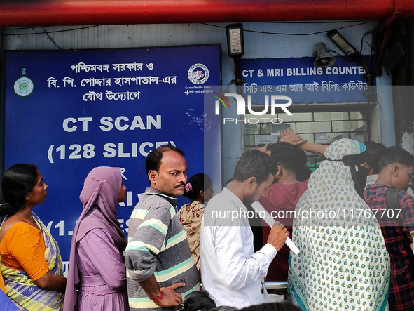 People stand outside a billing counter inside a government-run hospital in Kolkata, India, on November 11, 2024. 