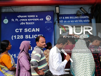 People stand outside a billing counter inside a government-run hospital in Kolkata, India, on November 11, 2024. (