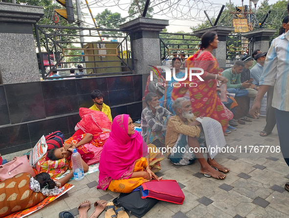 Patient relatives sit inside a government-run hospital in Kolkata, India, on November 11, 2024. 