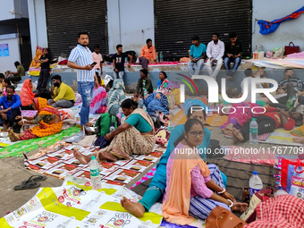 Patient relatives sit inside a government-run hospital in Kolkata, India, on November 11, 2024. (