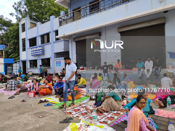 Patient relatives sit inside a government-run hospital in Kolkata, India, on November 11, 2024. 