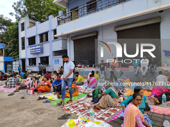 Patient relatives sit inside a government-run hospital in Kolkata, India, on November 11, 2024. (