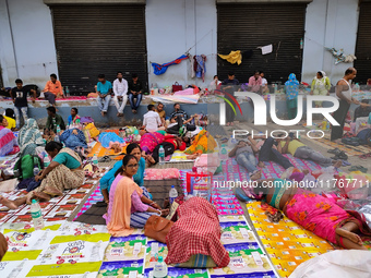 Patient relatives sit inside a government-run hospital in Kolkata, India, on November 11, 2024. (