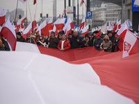 People carry a huge Polish national flag as they participate in the 106th anniversary of Poland's regaining its independence in Warsaw, Pola...