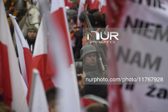 A man dressed as a WWII soldier marches as he participates in the 106th anniversary of Poland regaining its independence in Warsaw, Poland,...