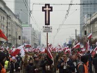 People wave Poland's national flags as they participate in the 106th anniversary of Poland regaining its independence in Warsaw, Poland, on...