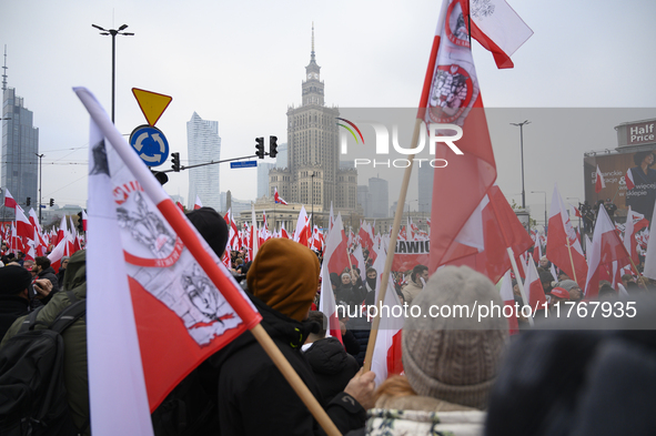 People wave Poland's national flags as they participate in the 106th anniversary of Poland regaining its independence in Warsaw, Poland, on...