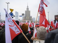 People wave Poland's national flags as they participate in the 106th anniversary of Poland regaining its independence in Warsaw, Poland, on...