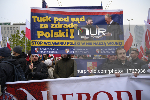 People carry a banner that depicts Ukraine's president Volodymyr Zelenskyy and Polish Prime Minister Donald Tusk and reads ''Tusk to the cou...