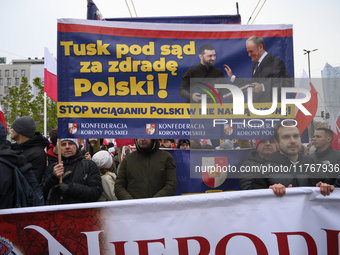 People carry a banner that depicts Ukraine's president Volodymyr Zelenskyy and Polish Prime Minister Donald Tusk and reads ''Tusk to the cou...