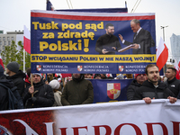 People carry a banner that depicts Ukraine's president Volodymyr Zelenskyy and Polish Prime Minister Donald Tusk and reads ''Tusk to the cou...