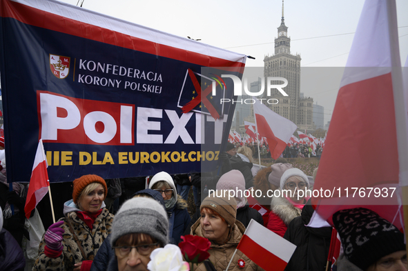 People carry a banner that reads ''PolExit'' as they participate in the 106th anniversary of Poland regaining its independence in Warsaw, Po...