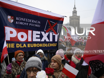 People carry a banner that reads ''PolExit'' as they participate in the 106th anniversary of Poland regaining its independence in Warsaw, Po...