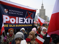 People carry a banner that reads ''PolExit'' as they participate in the 106th anniversary of Poland regaining its independence in Warsaw, Po...