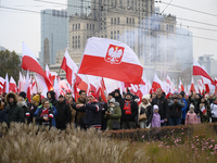 People wave Poland's national flags as they participate in the 106th anniversary of Poland regaining its independence in Warsaw, Poland, on...