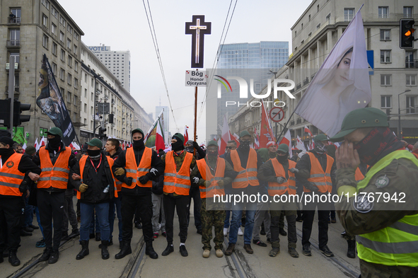 Security members of the Independence march hold the line as they participate in the 106th anniversary of Poland regaining its independence i...