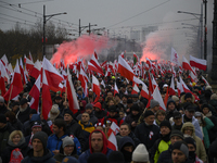 People wave Poland's national flags as they participate in the 106th anniversary of Poland regaining its independence in Warsaw, Poland, on...