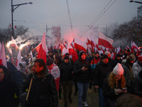 People wave Poland's national flags as they participate in the 106th anniversary of Poland regaining its independence in Warsaw, Poland, on...