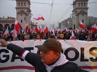 People wave Poland's national flags as they participate in the 106th anniversary of Poland regaining its independence in Warsaw, Poland, on...