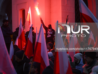 People wave Poland's national flags and light flares as they participate in the 106th anniversary of Poland regaining its independence in Wa...