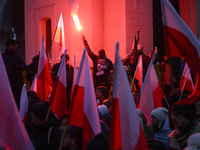 People wave Poland's national flags and light flares as they participate in the 106th anniversary of Poland regaining its independence in Wa...