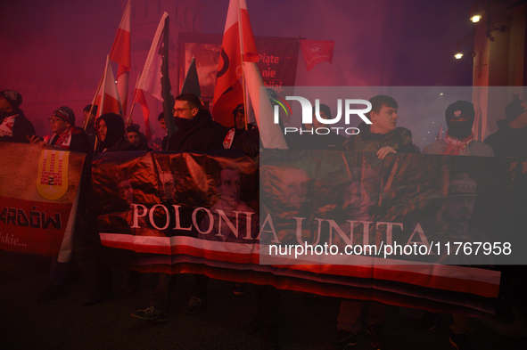 People carry a banner that reads ''Polonia Unita'' as they participate in the 106th anniversary of Poland's regaining its independence in Wa...