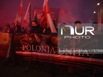 People carry a banner that reads ''Polonia Unita'' as they participate in the 106th anniversary of Poland's regaining its independence in Wa...