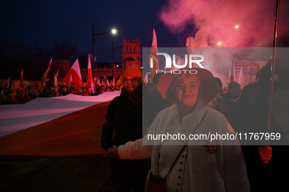 People carry a huge Polish national flag as they participate in the 106th anniversary of Poland's regaining its independence in Warsaw, Pola...