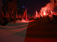 People carry a huge Polish national flag as they participate in the 106th anniversary of Poland's regaining its independence in Warsaw, Pola...