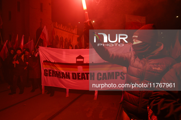 People carry a banner that reads ''German death camps'' as they participate in the 106th anniversary of Poland regaining its independence in...