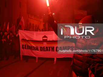 People carry a banner that reads ''German death camps'' as they participate in the 106th anniversary of Poland regaining its independence in...