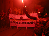 People carry a banner that reads ''German death camps'' as they participate in the 106th anniversary of Poland regaining its independence in...