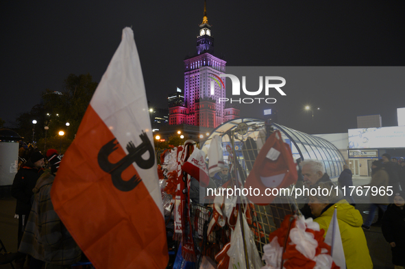 People buy patriotic merchandise as they participate in the 106th anniversary of Poland regaining its independence in Warsaw, Poland, on Nov...