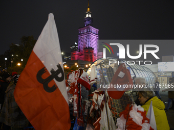 People buy patriotic merchandise as they participate in the 106th anniversary of Poland regaining its independence in Warsaw, Poland, on Nov...