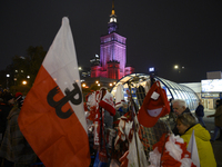 People buy patriotic merchandise as they participate in the 106th anniversary of Poland regaining its independence in Warsaw, Poland, on Nov...