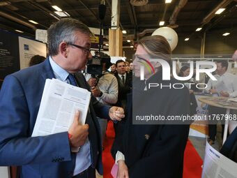 French Minister of Labor and Employment Astrid Panosyan-Bouvet (R) speaks with former French centrist UDI Member of Parliament Yves Jego (L)...