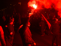 Participants light flares in Warsaw, Poland on 11 November, 2024. A march organized by far-right, nationalist organizations was allowed to p...